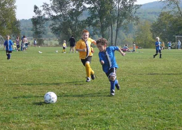 image of children playing soccer